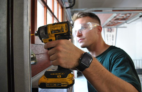 Technician Repairing Garage Door